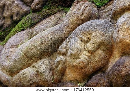 Stone altar carved into the sandstone - detail of the head of a praying angel