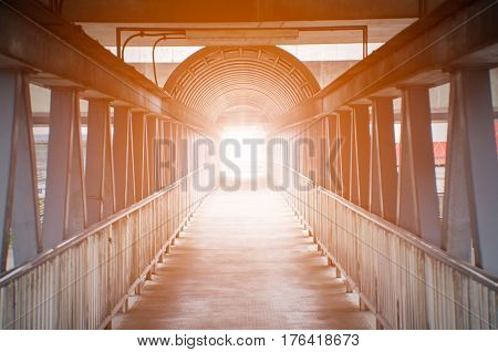 Orange light on pedestrian overpass concept for light discovery.