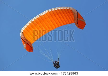 Paraglider descending his wing under big ears