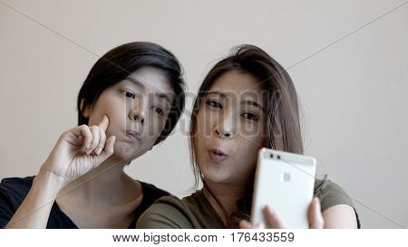 Two Happy Photogenic Asian Womans Talking Selfie With Phone