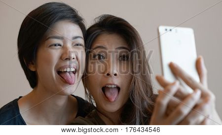 Two Happy Photogenic Asian Womans Talking Selfie With Phone