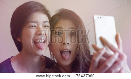 Two Happy Photogenic Asian Womans Talking Selfie With Phone