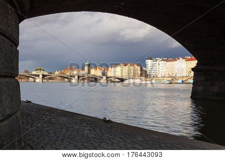 Prague Czech Republic - March 3 2017: View on the Prague panorama under the bridge after rain.The Prague bridges arching over the Vltava River are not only vital connecting links but also valuable works of architecture .