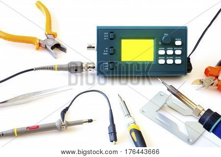 Modern digital signal oscilloscope and tools isolated on white background closeup