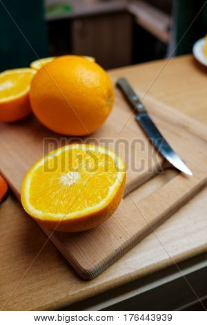 Fresh ripe oranges and juice on wooden table. Top view Orange in a cut on a wooden board. Citruses