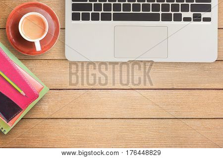 Notebooks and laptop with cup of coffee on office desk or wood table. top view with copy space for design