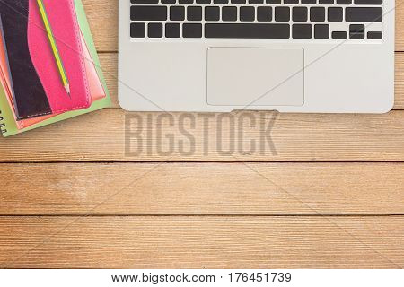 Notebooks and laptop on office desk or wood table. top view with copy space for design