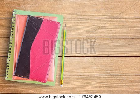 Notebooks and pencil on office desk or wood table. top view with copy space for design