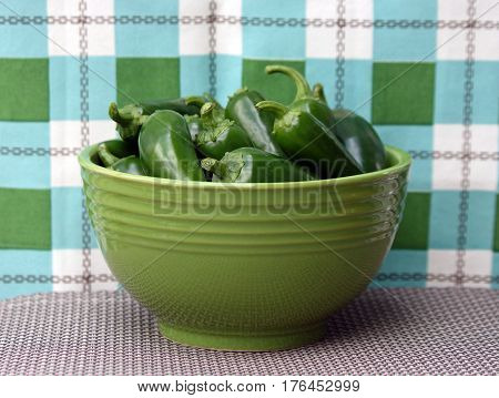 Closeup of a Green Bowl Of Green Jalepeno Peppers
