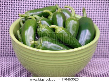 Closeup of a Green Bowl Of Green Jalepeno Peppers