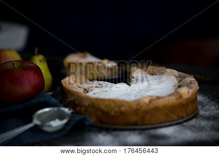 Homemade apple pie. Apple pie tart, ingredients - apples and cinnamon on rustic wooden background