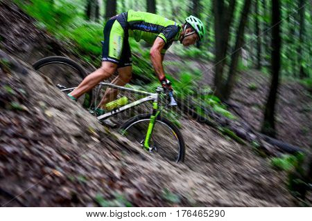 Lviv Ukraine - August 17 2016: MTB cyclist E. Zakora competing in the forest near Lviv in Ukraine at 4th round of amateur xc cup of Ukraine 2016.