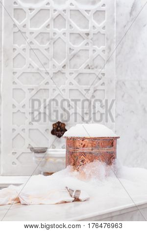 Towel And Copper Bowl With Soap Foam In Turkish Hamam. Traditional Interior Details