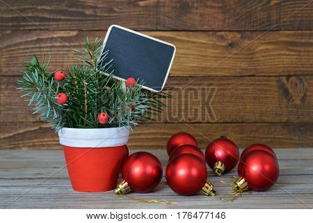 Christmas decoration and blank blackboard on wooden background