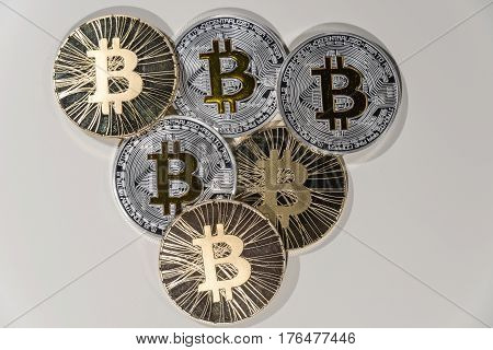 Shining metal BTC bitcoin coins on white background.