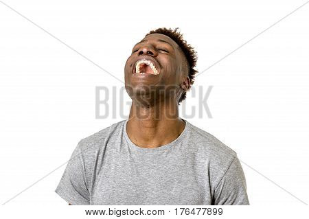 close up portrait of young attractive black african american man laughing happy and excited isolated on white background