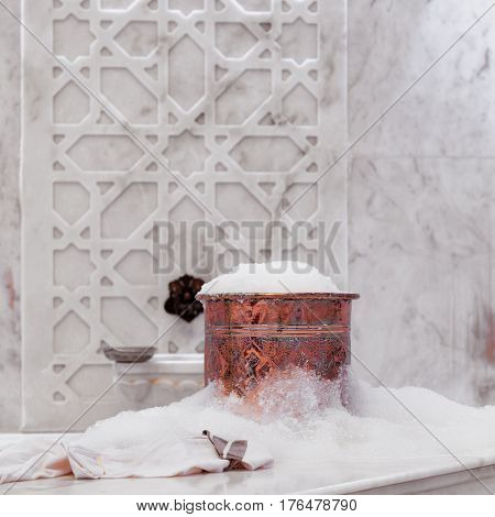 Towel And Copper Bowl With Soap Foam In Turkish Hamam. Traditional Interior Details