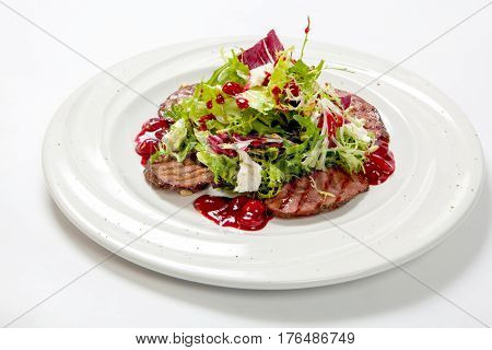 Salad With Grilled Veal And Fresh Salad Leaves On A White Plate