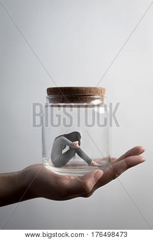 the depression woman sit imprisoned in jar
