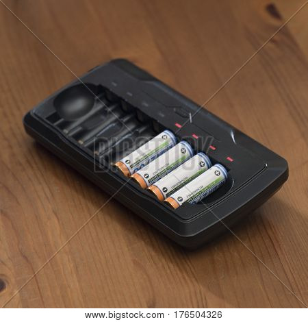 The charger and battery charging battery indicators and burning light bulb without wires.
