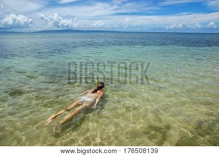 Young woman snorkeling in clear water on Taveuni Island Fiji. Taveuni is the third largest island in Fiji.