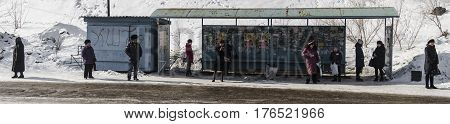 Kazakhstan, Ust-Kamenogorsk, march 7, 2017: People at the bus stop waiting for the bus