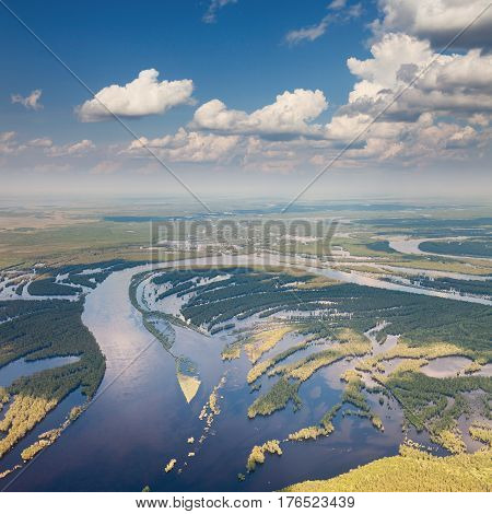 Aerial view river in flooded forest plains during summer.