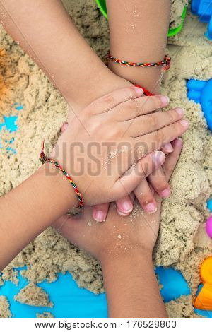 Childs Hand Close Up Playing Kinetic Sand