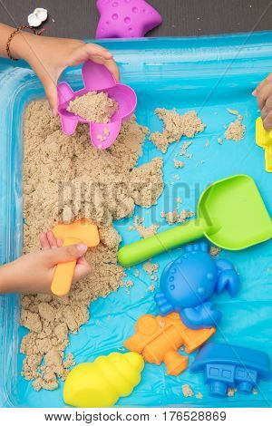 Child's Hand Close Up Playing Kinetic Sand