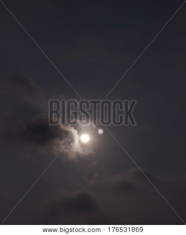 Sun shine in dark cloudy sky background.