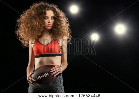 Sensual Young Sportswoman With Culry Hair Holding Rugby Ball