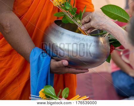 Offer sacrifice flowers to monk, Buddhist  religion