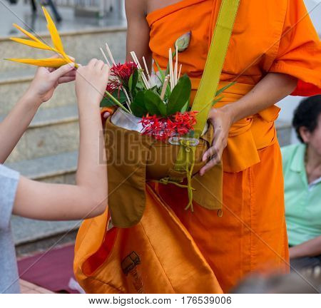 Offer sacrifice flowers to monk, Buddhist  religion
