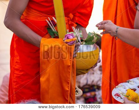Offer sacrifice flowers to monk, Buddhist  religion