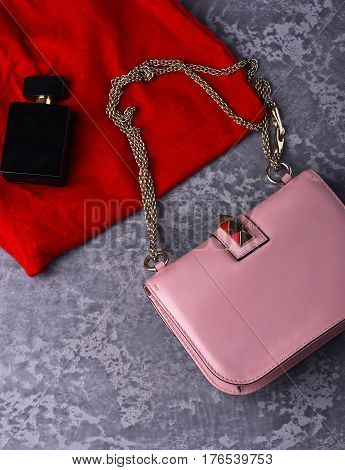 Small Womans Leather Pink Bag With Red Skirt And Perfume