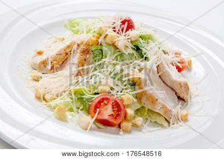 Caesar Salad With Chicken On A White Round Plate