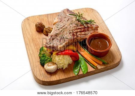 Grilled Foods - Bbq Beef Steak With Hot Sauce And Vegetables On A Wooden Board