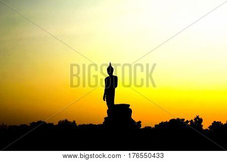 Sunset in Buddhist park in the Phutthamonthon district Buddhamonthon. Nakhon Pathom Province of Thailand. (Silhouette of Buddha)