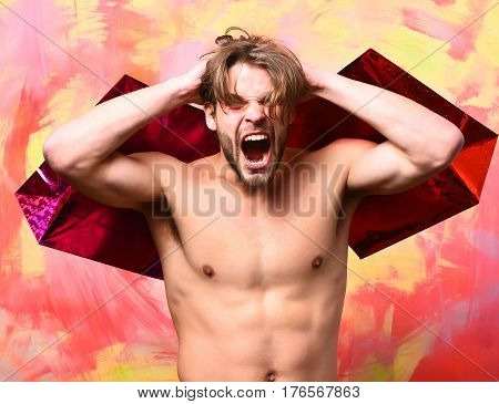 Caucasian Bearded Sexy Macho Man Holding Red Packages Or Bags