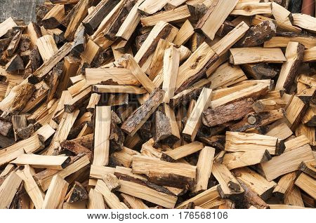 Pile of cut and cleaved firewood closeup as background