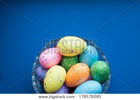 Easter Eggs In A Crystal Dish On A Blue Background,