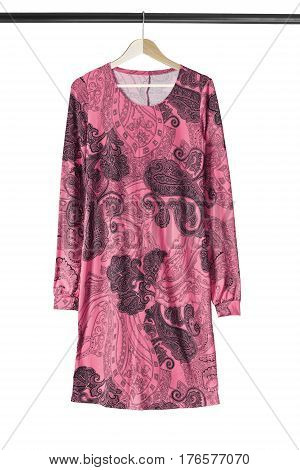Pink oriental silk dress on wooden clothes rack isolated over white