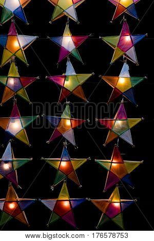 Multi colored star lamps and background .
