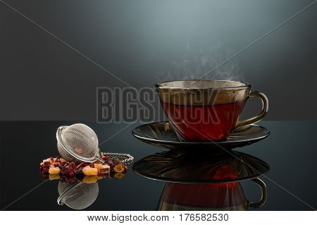 Steaming forest berry cocktail tea on a glossy surface