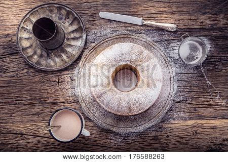 Marble cake.Easter Cake. Marble cake cup of coffee powder sugar and kitchen vintage utensil.