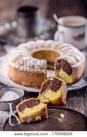 Marble cake.Easter Cake. Marble cake cup of coffee powder sugar and kitchen vintage utensil.