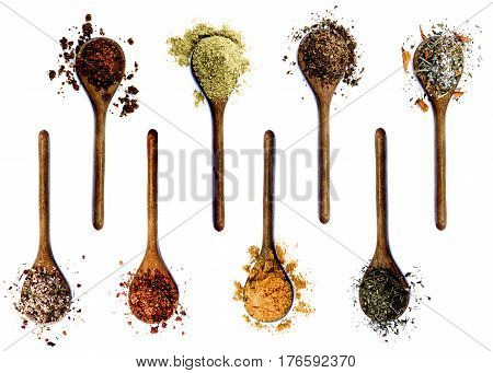 Collection of Various Spices in Wooden Spoons: Dried Paprika Cumin Powder Salt with Petals with Chili and with Cayenne Pepper Curry Powder and Thyme isolated on White background