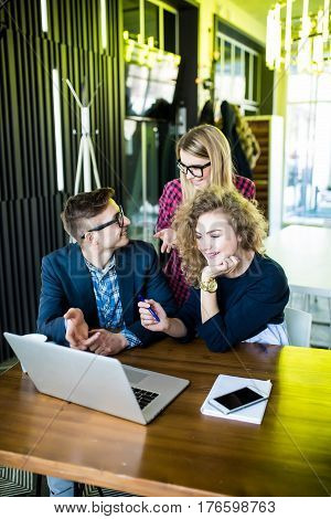 Three Young People Working Together On A New Project. Team Of Happy Office People Working On Laptop