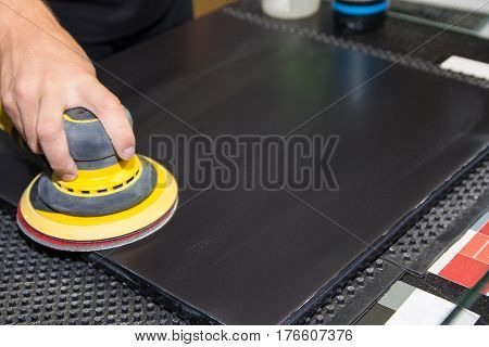Hand of the worker is a polishing machine. Industry