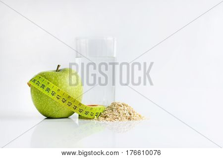 Healthy nutrition. green apple and tape measure